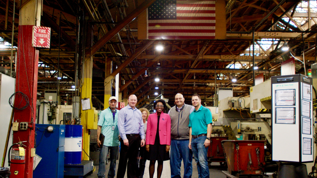 Congresswoman Underwood smiles next to constituents at Burgess-Norton Manufacturing Company.